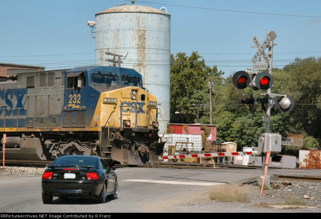 Car driver prudently waits for CSX 232 to clear the crossing